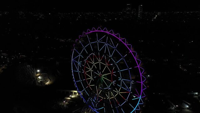 Aerial night panorama: Vibrant Ferris wheel at Aztlan, Parque Urbano, Chapultepec