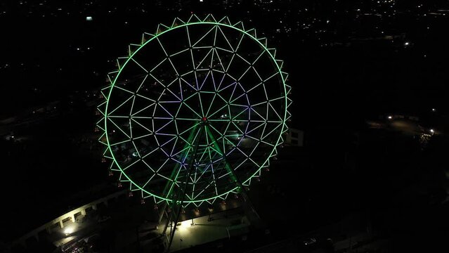 Aerial night panorama: Vibrant Ferris wheel at Aztlan, Parque Urbano, Chapultepec