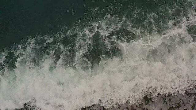 Aerial Drone Top View of Turquoise Ocean Waves Crashing Over the Sandy Shores of the Philippines.