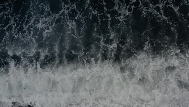 Top View of Dark Blue Ocean Waves Raging Over a Coastal Beach in the Philippines.