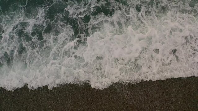 Turquoise Ocean Water Waves Raging Over Coastal Shoreline Beach Top View from Aerial Drone in Philippines.