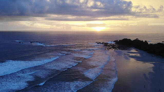 Intense sunset over Playa Guiones, vast seascape. Nosara, Costa Rica