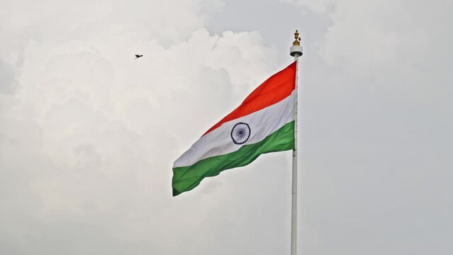 indian flag swaying in the sky with clouds and eagle flying  slow motion daytime 4k 25p