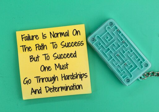 colored paper and words quote failure is normal on the path to success but to succeed one must go through hardships and determination. the concept of motivation to succeed