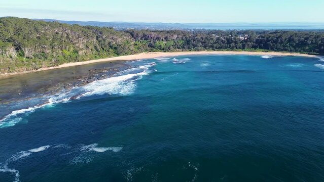 Drone aerial landscape bushland shot of sandy beach bay nature travel tourism ocean waves NSW Bateau Bay Central Coast Australia 4K