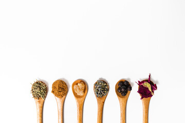 A flat lay of raw natural skincare ingredients on a white background