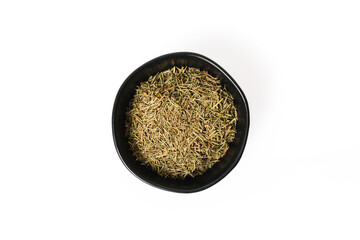 A ceramic bowl of rosemary seasoning on a white background