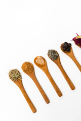 Natural wood spoons with herbal ingredients for skincare products