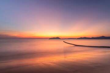 Dancing Shadows: Palm Tree Trunk in Sunset's Embrace