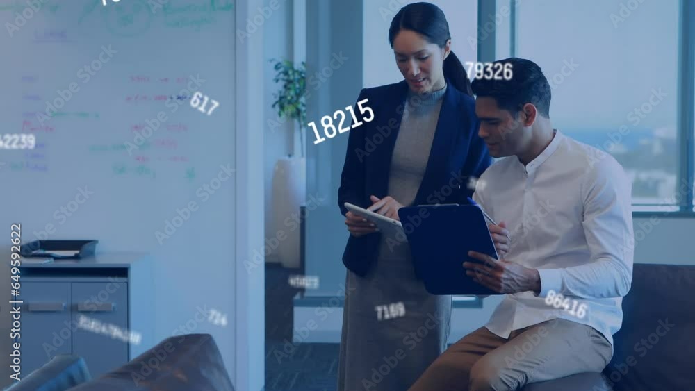 Poster animation of changing numbers over diverse coworkers discussing reports on desk in office