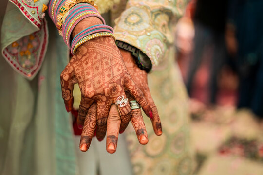 Indian groom and bride hand in hand showing ring
