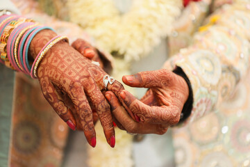 Indian groom and bride hand in hand showing ring