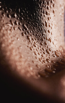 Skin, water drops and closeup of a person for dermatology, skincare and hygiene. Zoom on aesthetic model for art deco, human and wet or sweat on body with droplets, creative and wellness background