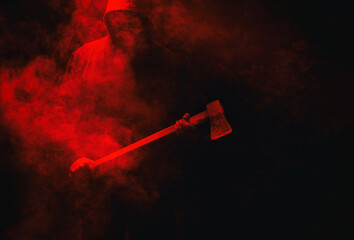 A maniac with an ax on a dark red background with smoke.