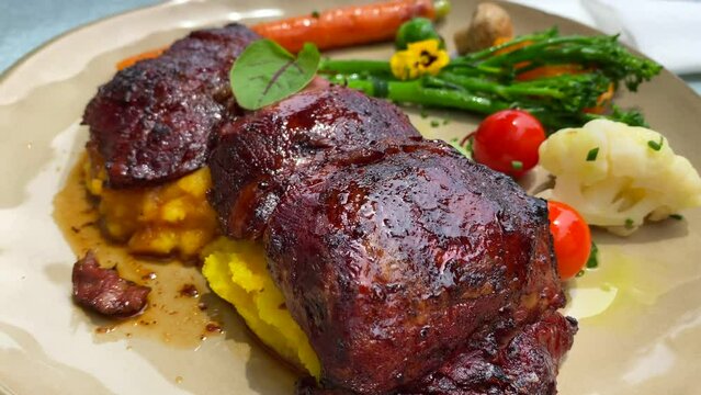 Delicious tender beef cheecks with creamy polenta and vegetables, fancy restaurant dining experience, 4K shot