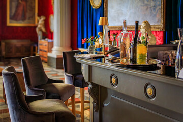 Bar counter with drinks waiting for customers and a colorful luxury interior at a luxury bar in the...