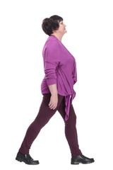 Fototapeta premium casual elderly woman in a purple blouse striding forward.