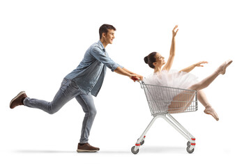 Guy pushing a ballerina inside a shopping cart