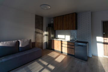 Modern small room with kitchen area and wooden floor