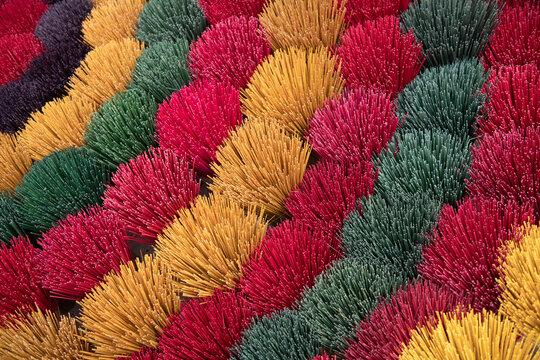closeup of colorful bundles in pattern of incense in Vietnam