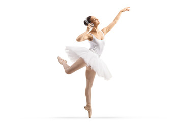 Full length profile shot of a ballerina dancing with headphones
