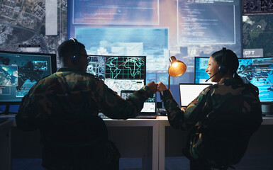 Control room, military and fist bump by soldier team on surveillance together at night for...