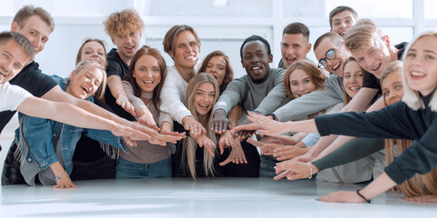 multinational group of young people joining their palms
