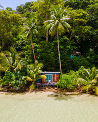 Beach bungalow at the beach of Koh Kood Island Thailand Trat , tropical beach with palm trees and a...