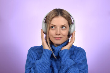 cute blonde woman in headphones looking away