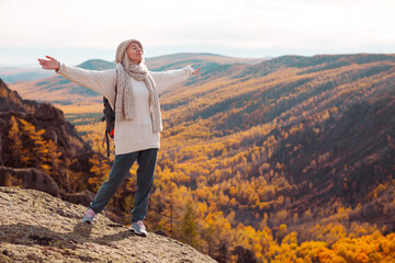Freedom Traveler Woman with Backpack standing with Raised arms and enjoying beautiful nature - 649612897