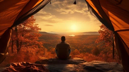 Behangcirkel Traveler holding relaxing inside a orange tent and enjoy the view of sunset on autumn forest in national park Generative ai © StockWorld