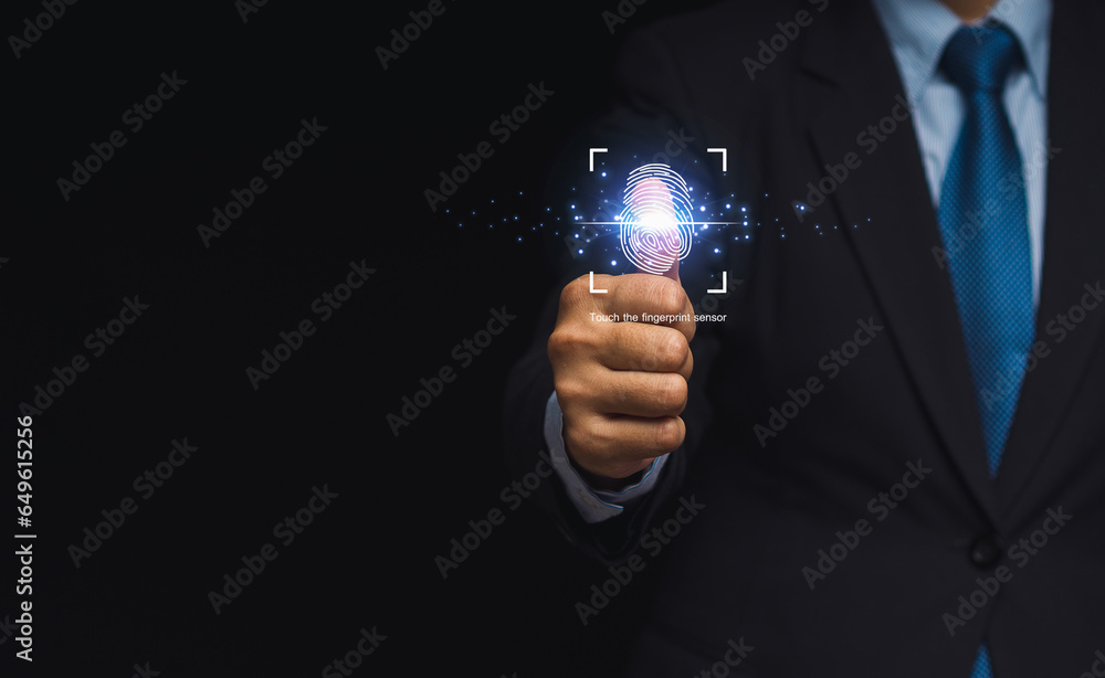 Poster a businessman login to the system with a fingerprint on the virtual screen while standing on a black