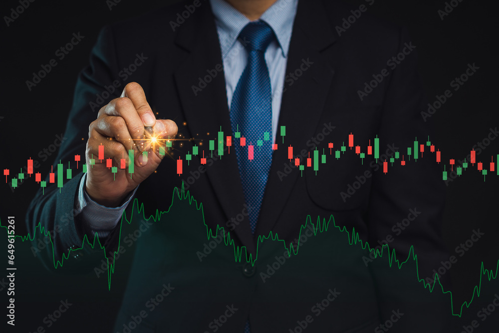 Poster businessman holding a pen pointing to graph stock on a virtual screen while standing on a black back