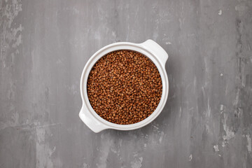 Raw toasted buckwheat in a white ceramic bowl