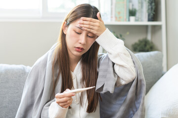 Sick, influenza asian young woman, girl have a fever, hand holding thermometer, touching forehead...