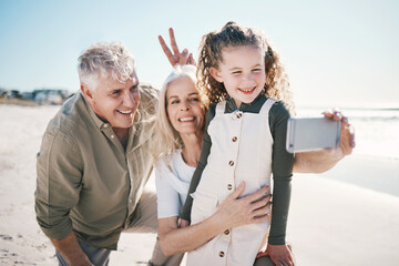 Family, selfie and beach holiday with peace sign, grandparents and young girl with a smile. Happy,...
