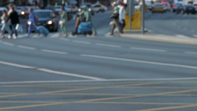 Group of people crossing road on walkway. 4k slow motion defocused footage