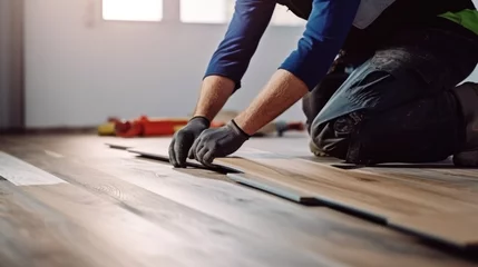 Fotobehang Professional builder man laying laminate flooring at home © sirisakboakaew