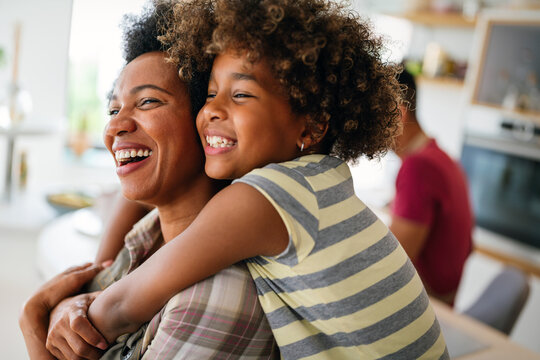 African american woman hugging her smiling teen daughter. Family love single parent child concept