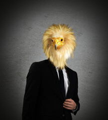 Portrait of businessman with bird face on dark background