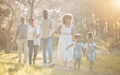 Big family in park, holding hands and walking together for love, bonding on nature adventure....