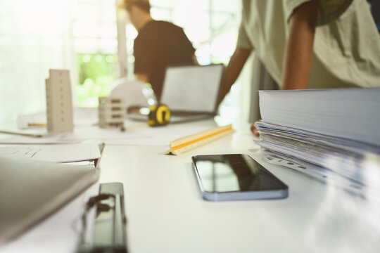 Architects Workplace With Digital Tablet, Safety Helmet And Blue Prints On Women Table In Modern Office