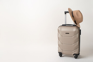 Travel in Vogue: Trendy luggage and wide brimmed hat, displayed from a side angle on a white background, providing an open canvas for text or advertisements