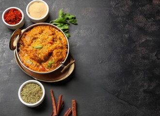 Traditional Indian food with spices on dark background with space for text. AI Generated.
