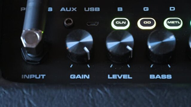 Man plug in jack on guitar amplifier. 4k video footage UHD 3840x2160