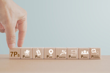 concept of 7ps of marketing mix. Hand hold wooden cube block with 7ps text and business icon on the...