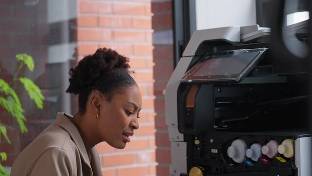 Businessman helping woman colleague using a photocopier machine in office. Photocopy machine was broken. Photocopier or printer has error