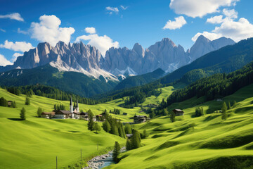 Panoramic view of idyllic mountain scenery in the Alps with fresh green meadows in bloom on a beautiful sunny day in springtime.