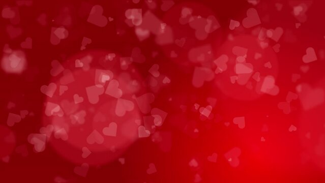 Red abstract background with small blurred flying hearts. Romantic looping animation with beautiful bokeh.