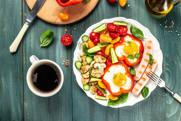 full english breakfast fried eggs, roasted sausages, tomatoes, mushrooms and vegetables on a wooden background. place for text, top view.